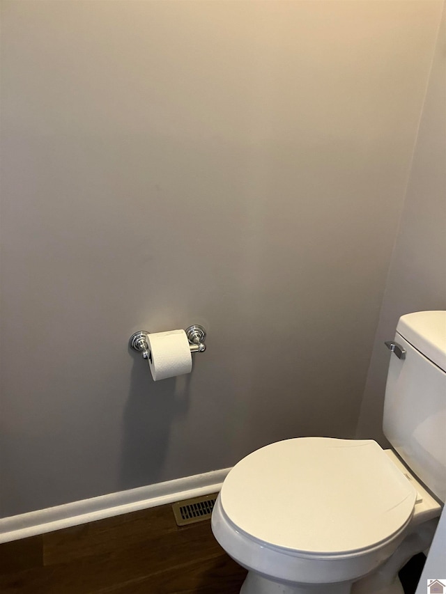 bathroom with hardwood / wood-style floors and toilet