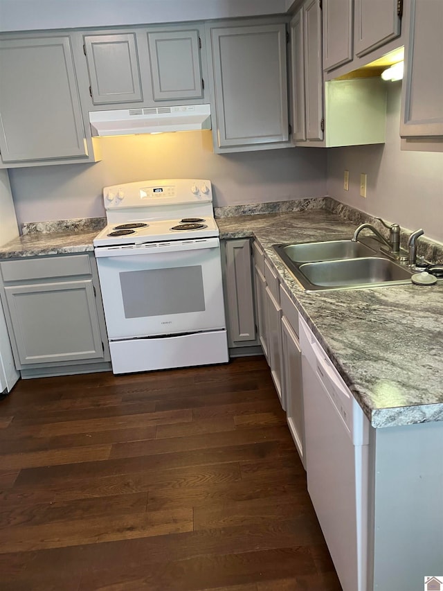 kitchen with white appliances, sink, dark hardwood / wood-style floors, and gray cabinetry