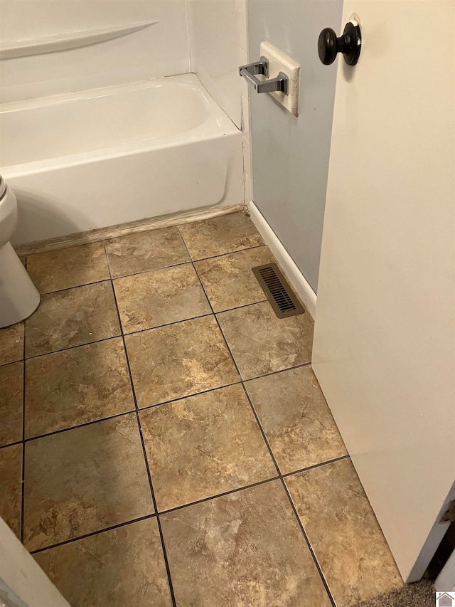 bathroom with tile floors and toilet