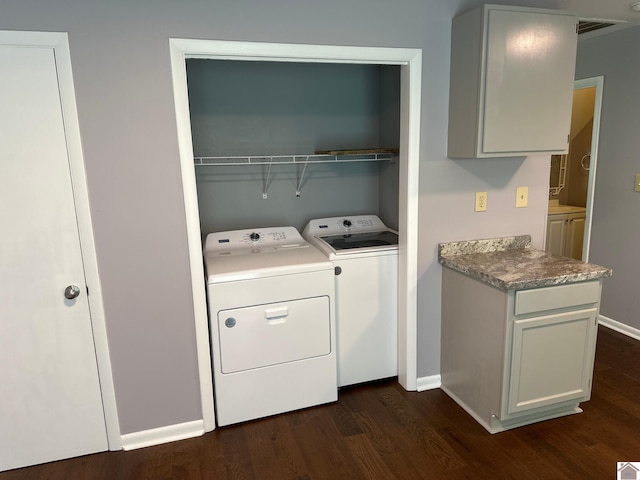 laundry area with dark hardwood / wood-style floors and independent washer and dryer