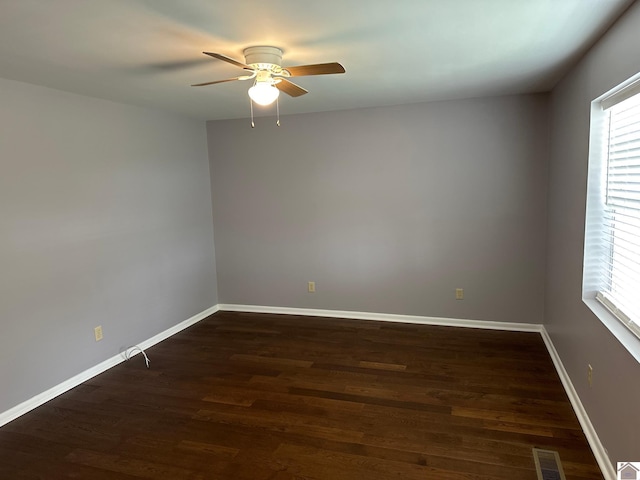 empty room featuring ceiling fan and dark hardwood / wood-style flooring