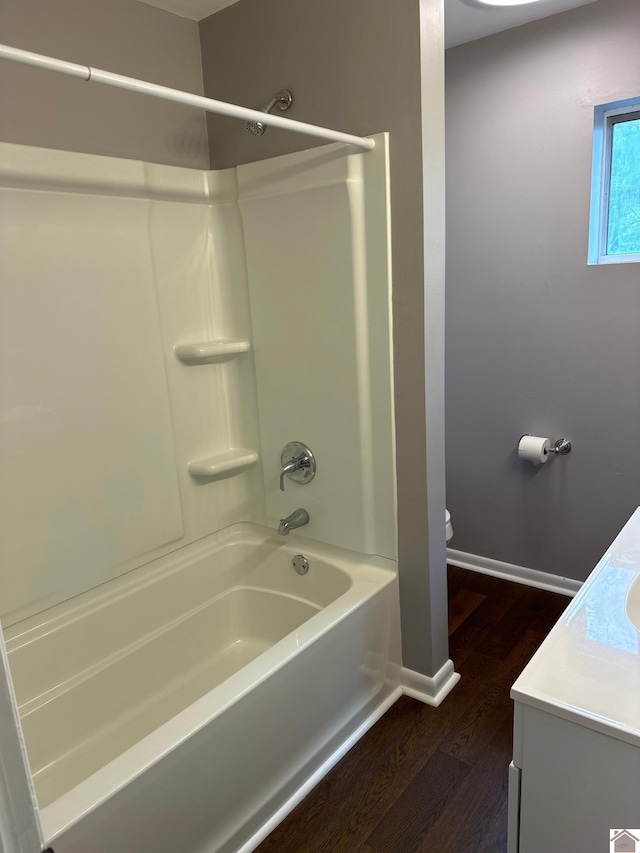 full bathroom with  shower combination, vanity, toilet, and hardwood / wood-style floors