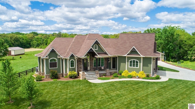 craftsman house with a front yard and a porch