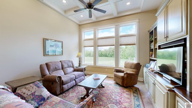 living room featuring beam ceiling, ceiling fan, and coffered ceiling