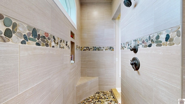 bathroom with tiled shower