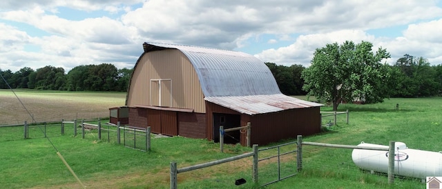 view of outbuilding featuring a rural view and a yard