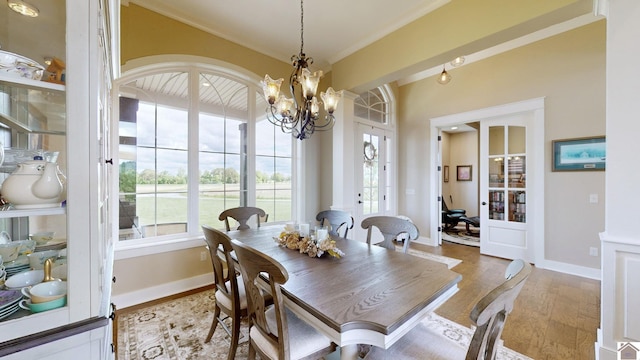 dining room with hardwood / wood-style floors and a notable chandelier