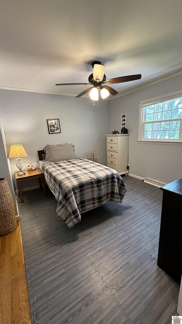 bedroom featuring ornamental molding, dark hardwood / wood-style floors, ceiling fan, and a baseboard radiator