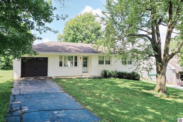 ranch-style house featuring a garage and a front lawn