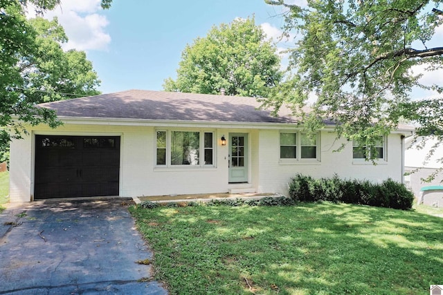 ranch-style house featuring a front yard and a garage