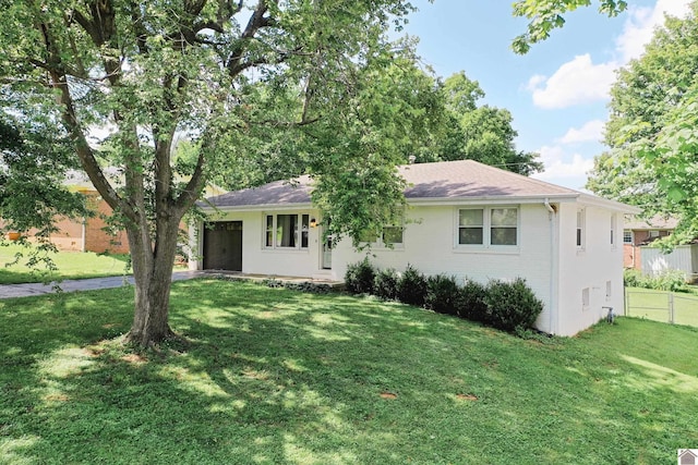 single story home featuring a garage and a front lawn