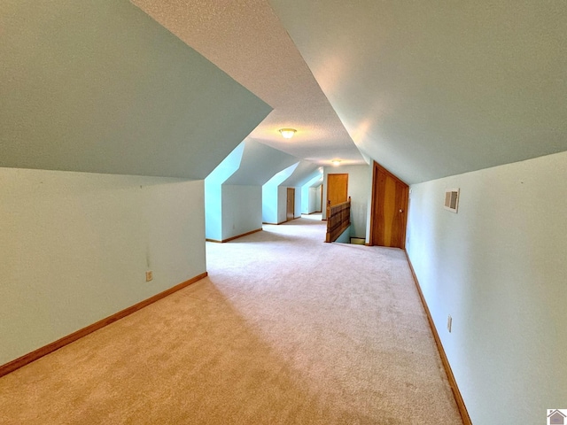 additional living space with light carpet and lofted ceiling