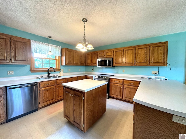 kitchen with pendant lighting, sink, a center island, a notable chandelier, and stainless steel appliances