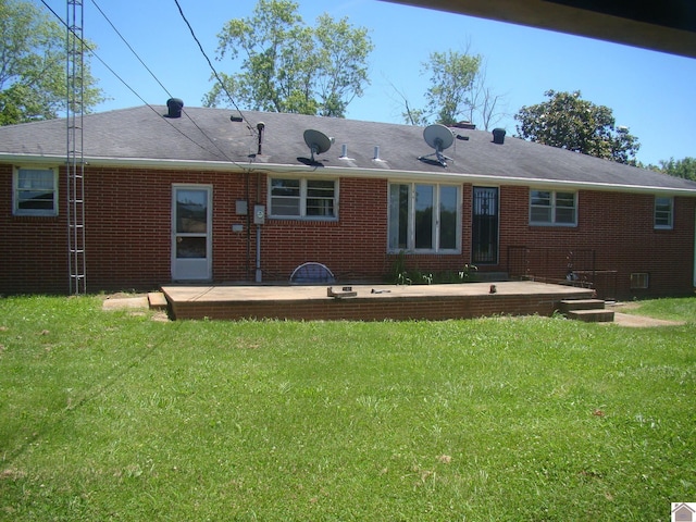 rear view of house featuring a yard and a patio area