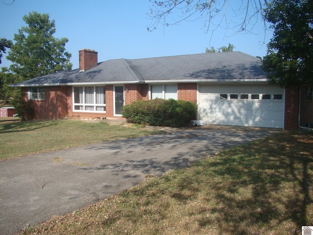 ranch-style home featuring a garage and a front yard