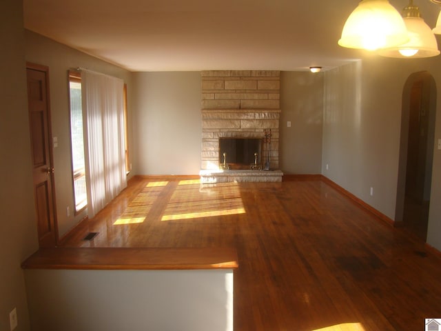 unfurnished living room featuring a fireplace and hardwood / wood-style flooring