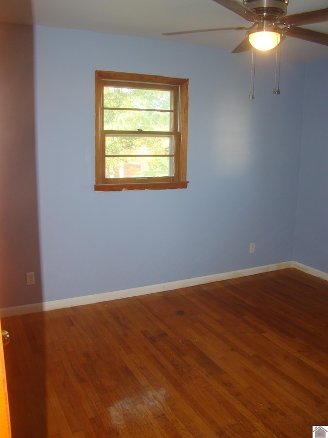 empty room featuring ceiling fan and wood-type flooring