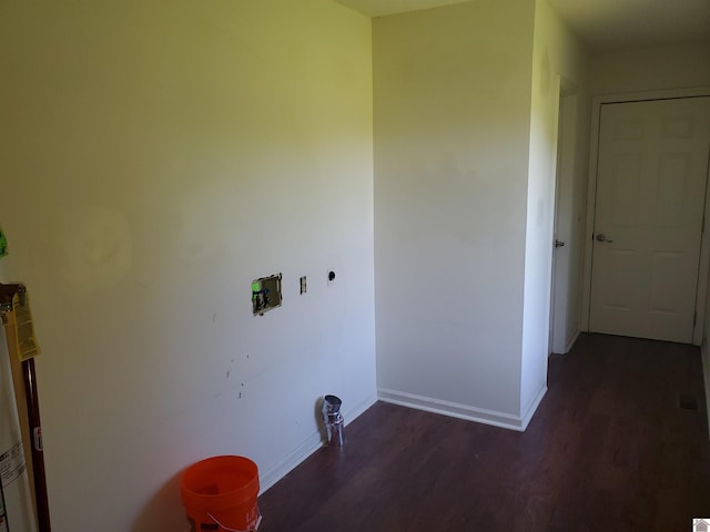 laundry area with dark wood-type flooring