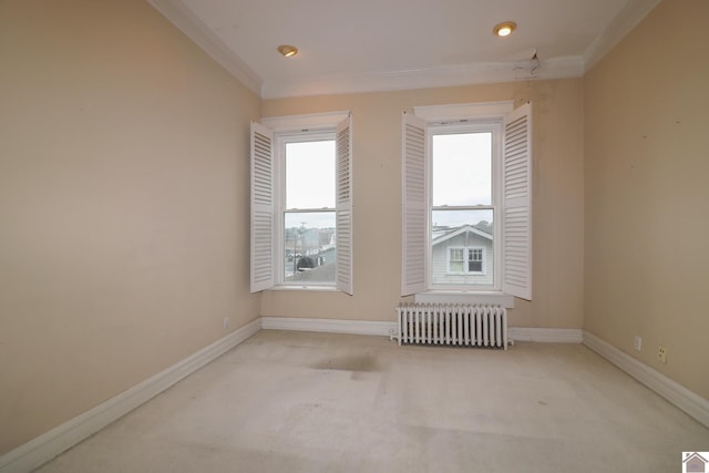 carpeted empty room featuring radiator heating unit and ornamental molding