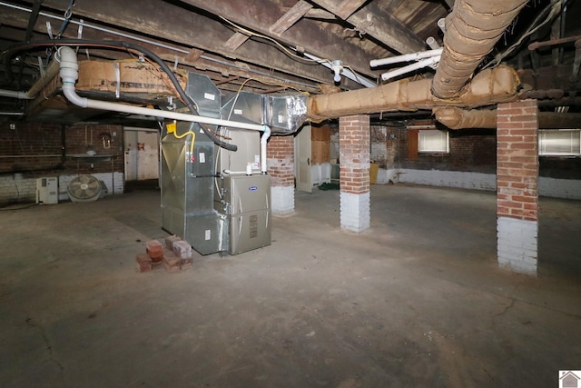 basement with brick wall and heating unit