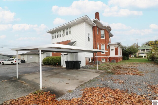 view of home's exterior featuring a carport and cooling unit