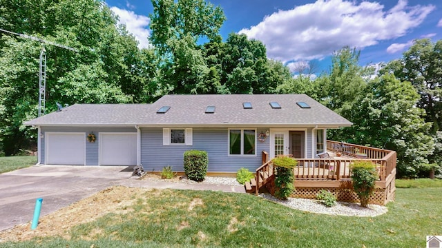 ranch-style home with a garage, a front lawn, and a deck