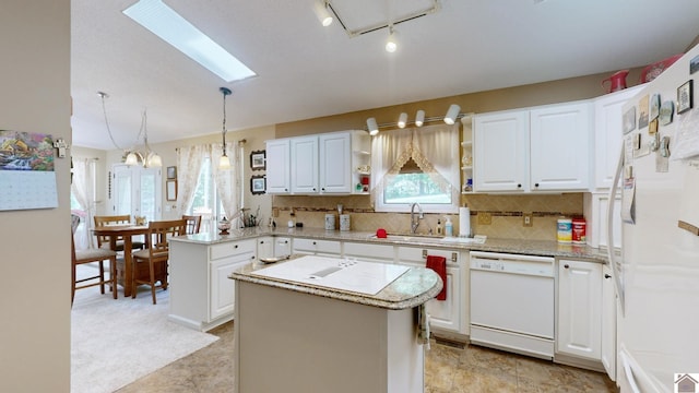 kitchen with white cabinetry, sink, pendant lighting, white appliances, and a kitchen island