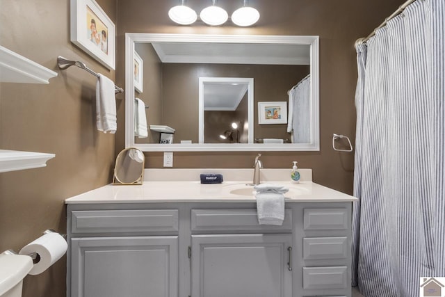 bathroom featuring vanity, toilet, and ornamental molding