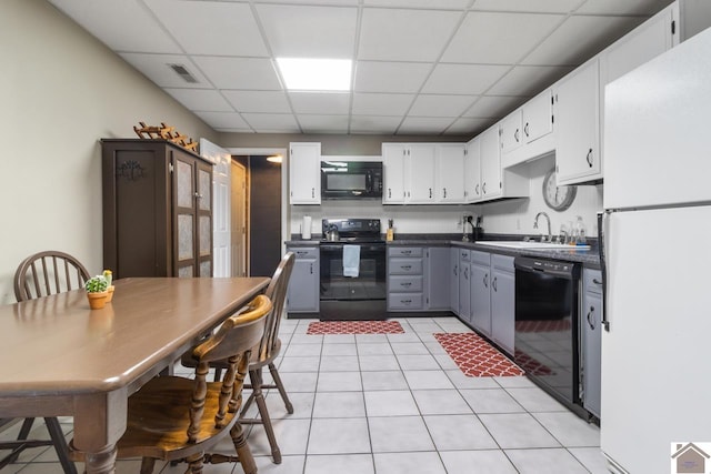 kitchen with a paneled ceiling, gray cabinetry, sink, black appliances, and white cabinets