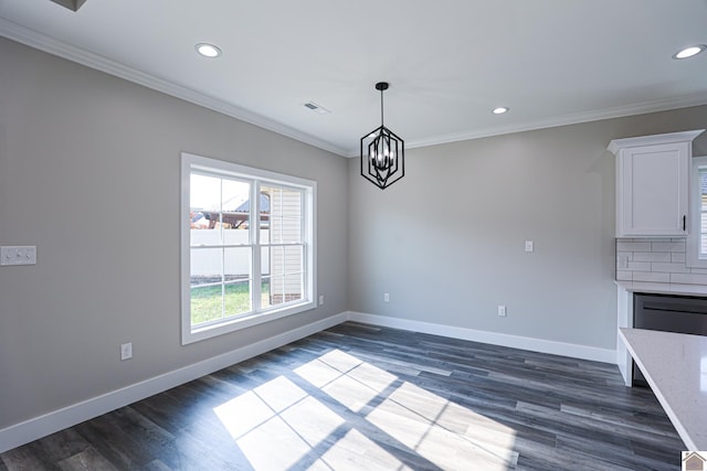 unfurnished dining area featuring a notable chandelier, ornamental molding, and dark wood-type flooring