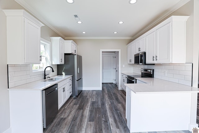 kitchen featuring decorative backsplash, stainless steel appliances, crown molding, sink, and white cabinetry