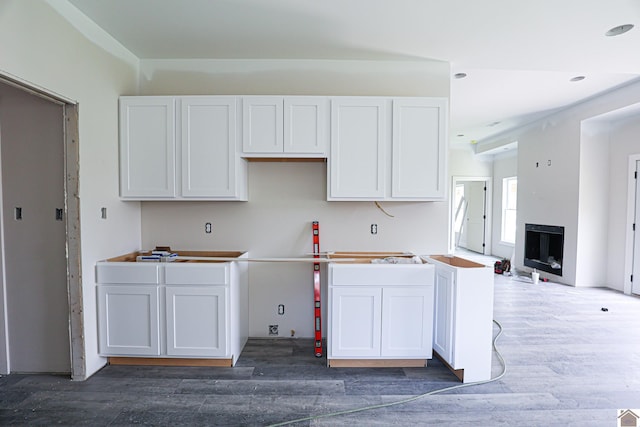 kitchen featuring dark hardwood / wood-style floors and white cabinetry