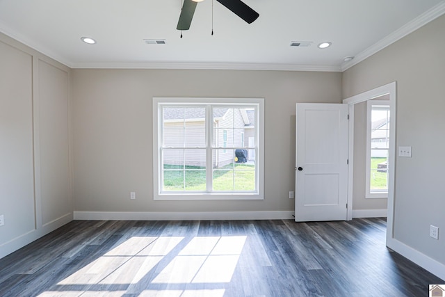 empty room with ornamental molding, visible vents, ceiling fan, and dark wood finished floors