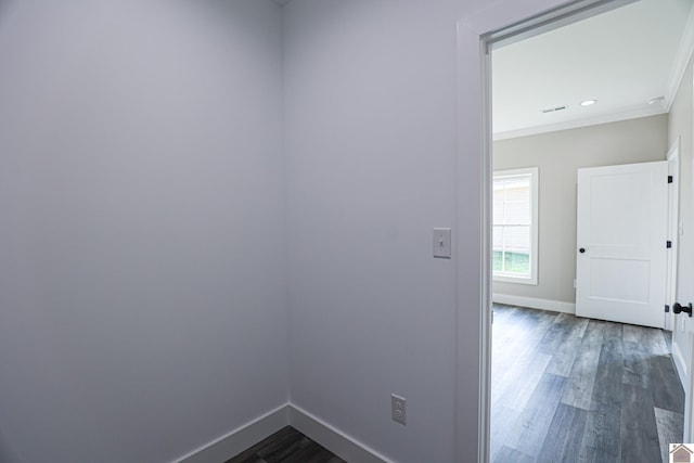 hallway with baseboards, dark wood-style flooring, and ornamental molding