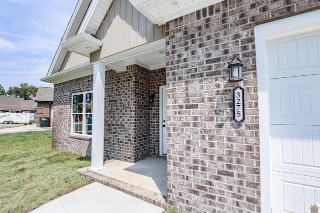 doorway to property featuring a lawn