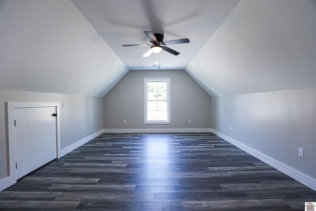 additional living space with dark hardwood / wood-style floors, vaulted ceiling, and ceiling fan