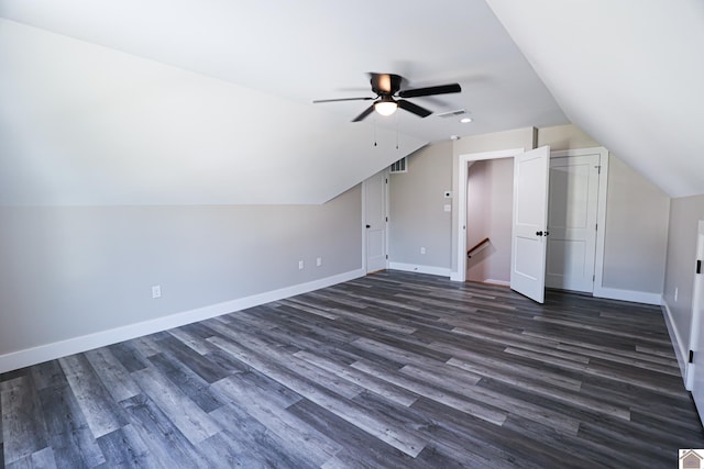 bonus room with dark wood finished floors, baseboards, vaulted ceiling, and ceiling fan