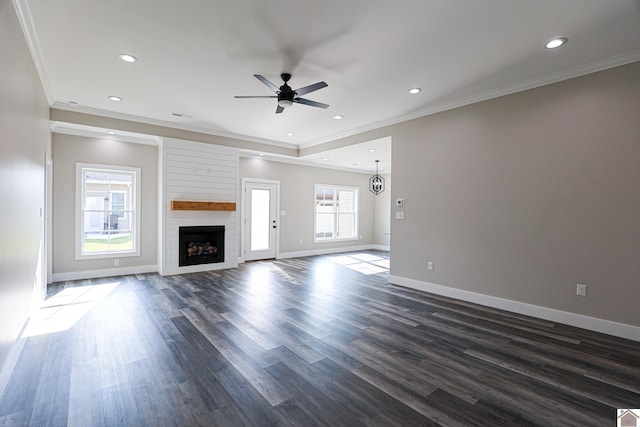 unfurnished living room with a fireplace, crown molding, ceiling fan, and dark wood-type flooring