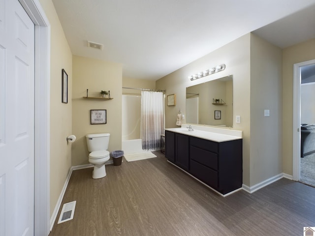 bathroom with vanity, toilet, and hardwood / wood-style flooring