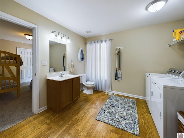 washroom featuring sink, carpet floors, and washer and clothes dryer