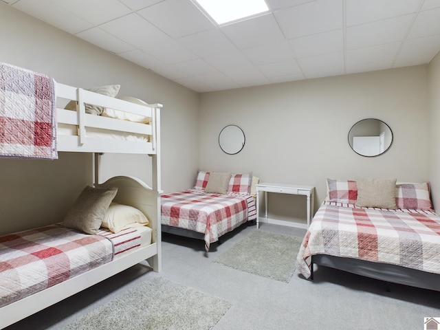 carpeted bedroom featuring a paneled ceiling