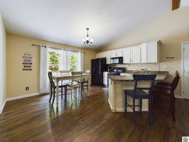 kitchen with white cabinetry, lofted ceiling, black appliances, dark hardwood / wood-style floors, and backsplash