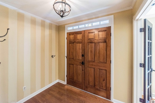 entrance foyer featuring a notable chandelier, crown molding, and dark wood-type flooring