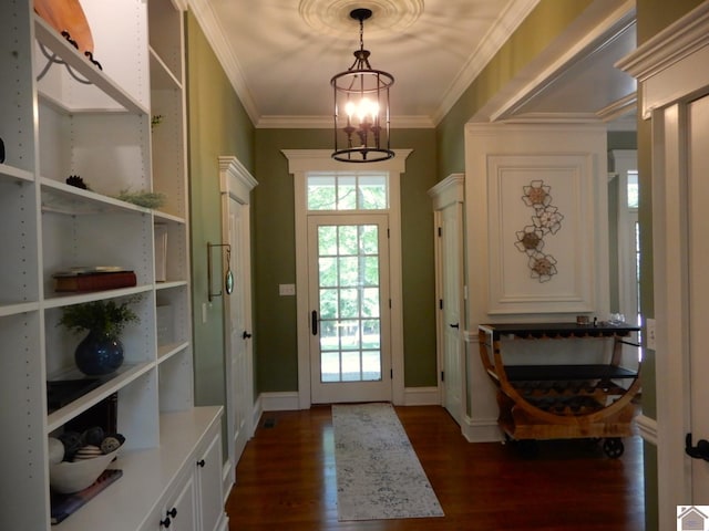 doorway featuring dark hardwood / wood-style flooring, crown molding, and a notable chandelier