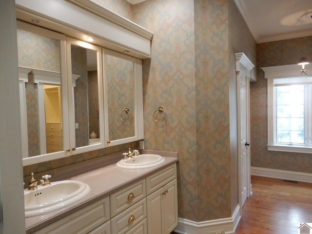 bathroom featuring hardwood / wood-style floors, vanity, and ornamental molding