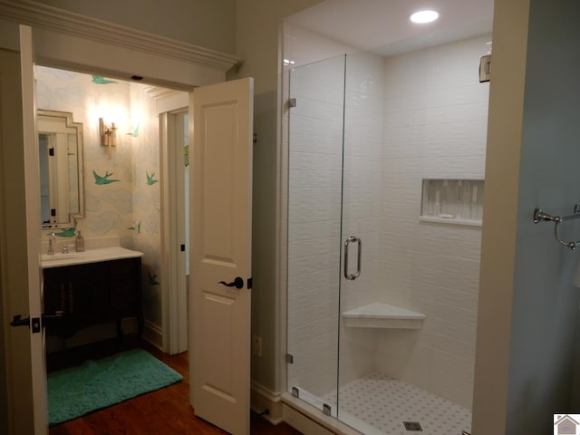 bathroom featuring vanity, wood-type flooring, and an enclosed shower