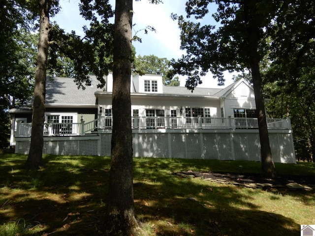 back of house with a lawn and a wooden deck