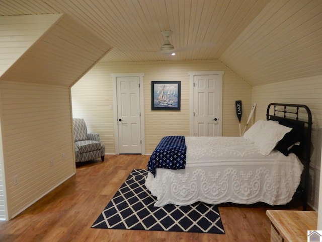 bedroom featuring ceiling fan, vaulted ceiling, a closet, and hardwood / wood-style flooring