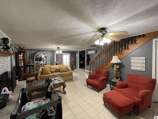 tiled living room featuring a textured ceiling, a brick fireplace, ceiling fan, and an AC wall unit