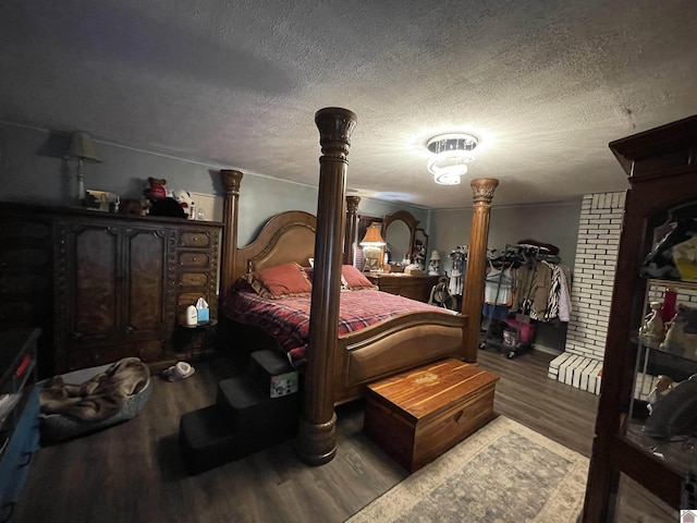 bedroom featuring hardwood / wood-style floors and a textured ceiling